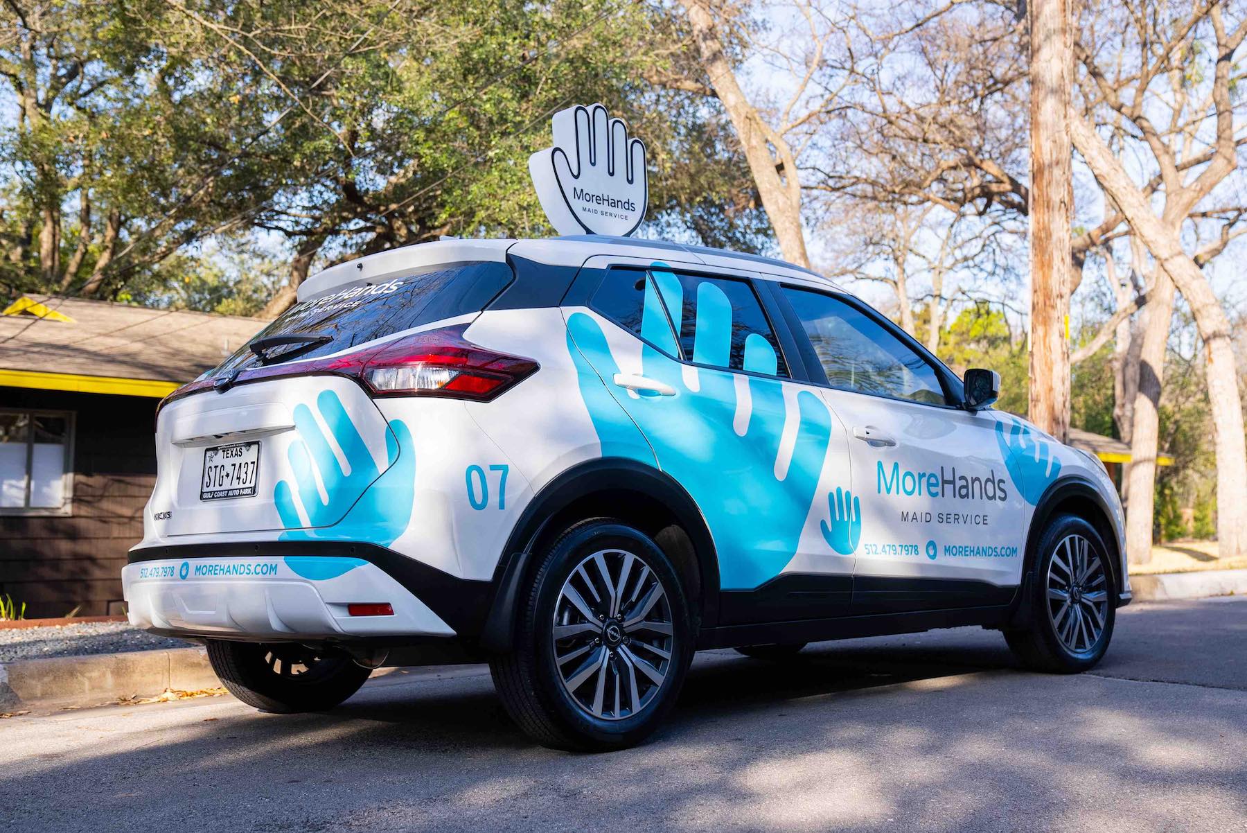 MoreHands branded car in Austin neighborhood